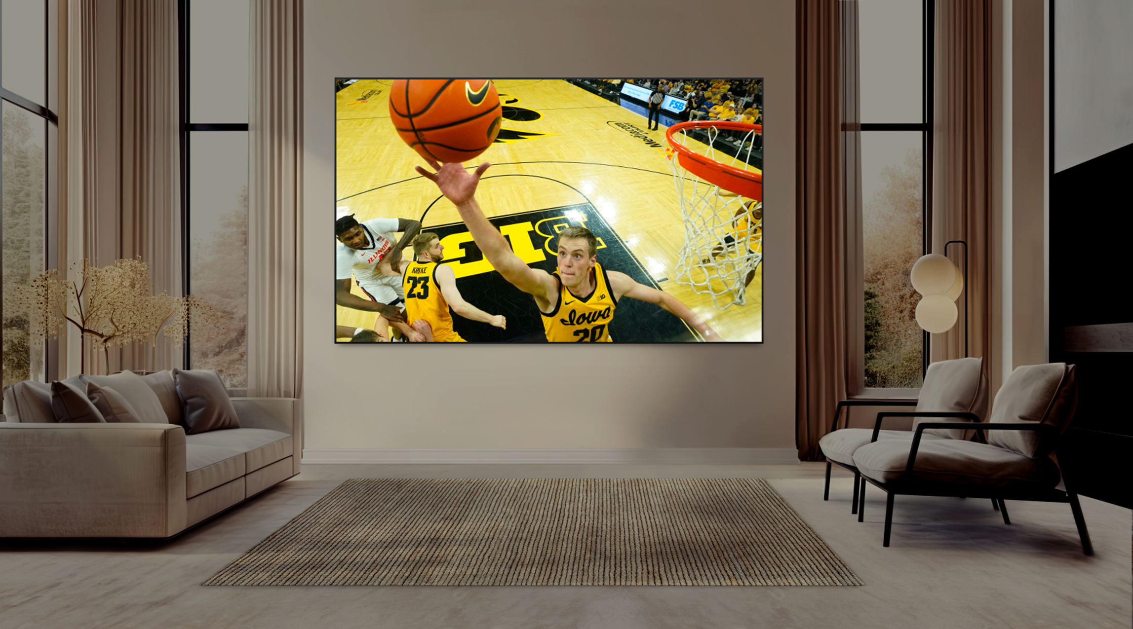 A modern living room with large windows and neutral decor features a big screen tv displaying a close up basketball action shotwhile highlighting bright ideas for home entertainment