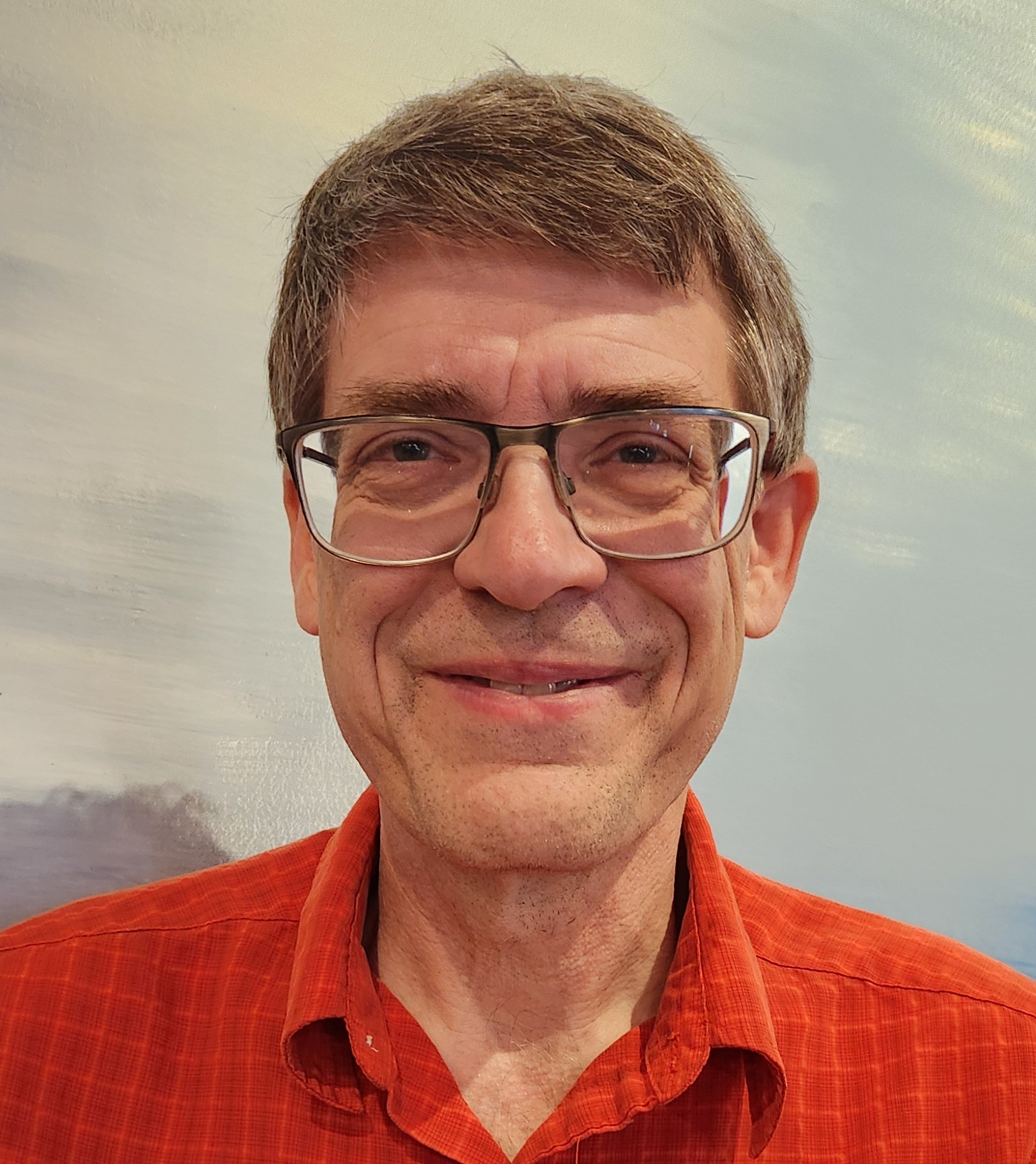 A middle aged man with short brown hair glasses and a red collared shirt smiles at the camera in front of a softly colored abstract background that evokes the feel of a luxury night sky A middle aged man with short brown hair glasses and a red collared shirt smiles at the camera in front of a softly colored abstract background that evokes the feel of a luxury night sky Luxurys new ceiling the night sky
