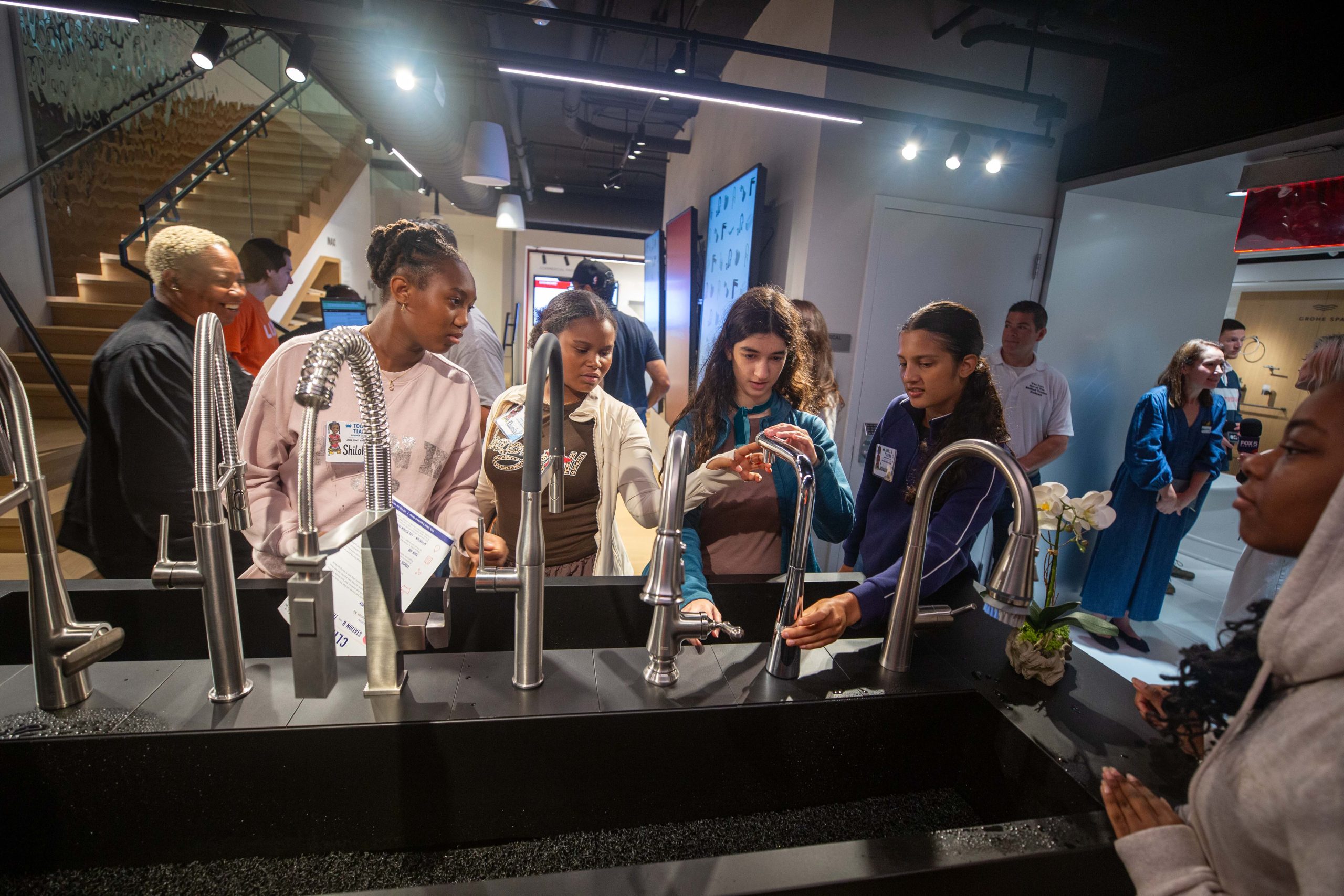 Young women learning about plumbing lixil lixil and tools & tiaras host interactive workshop to introduce teen girls to careers in plumbing 